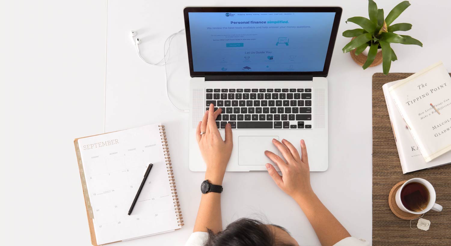 women at desk using computer to check website